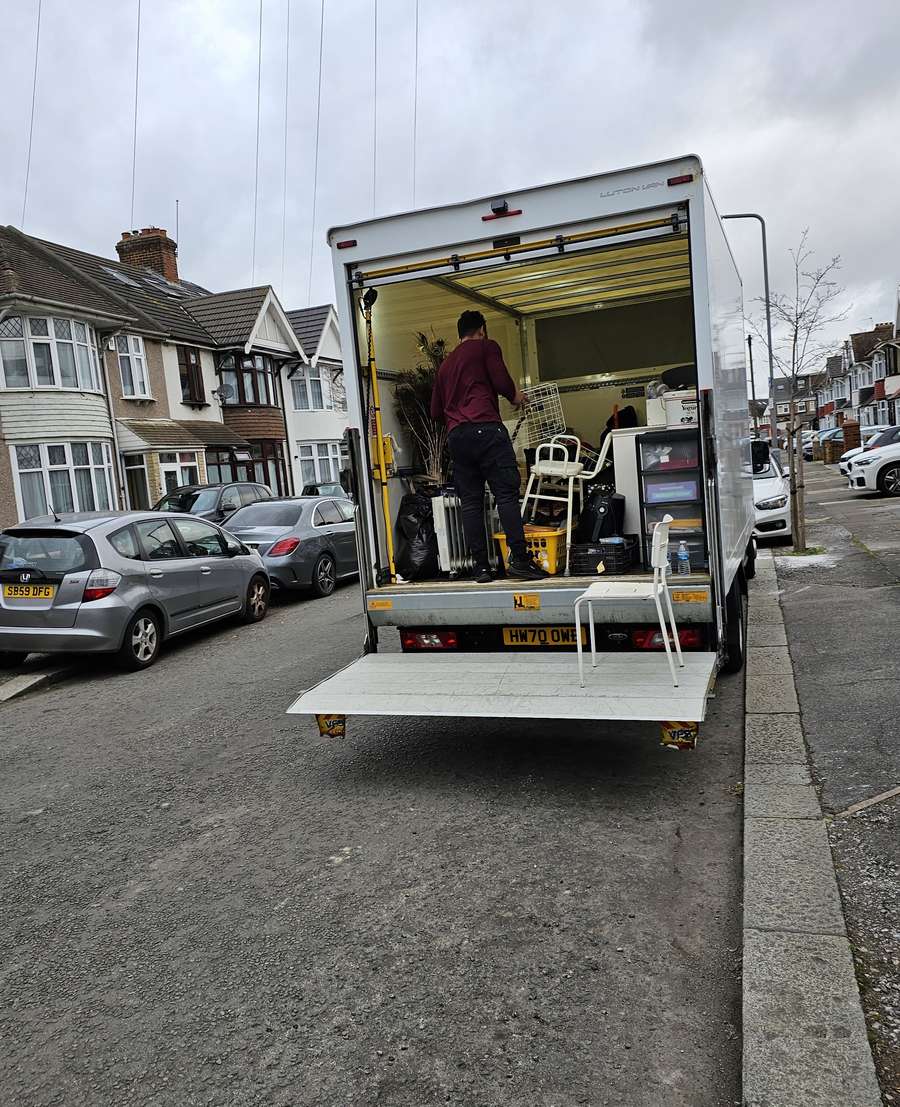Tanbir loading a Luton van outside a terraced house in East London
